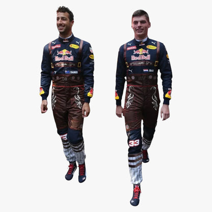 Two men modeling matching Red Bull Racing team jumpsuits and boots against a plain white background.