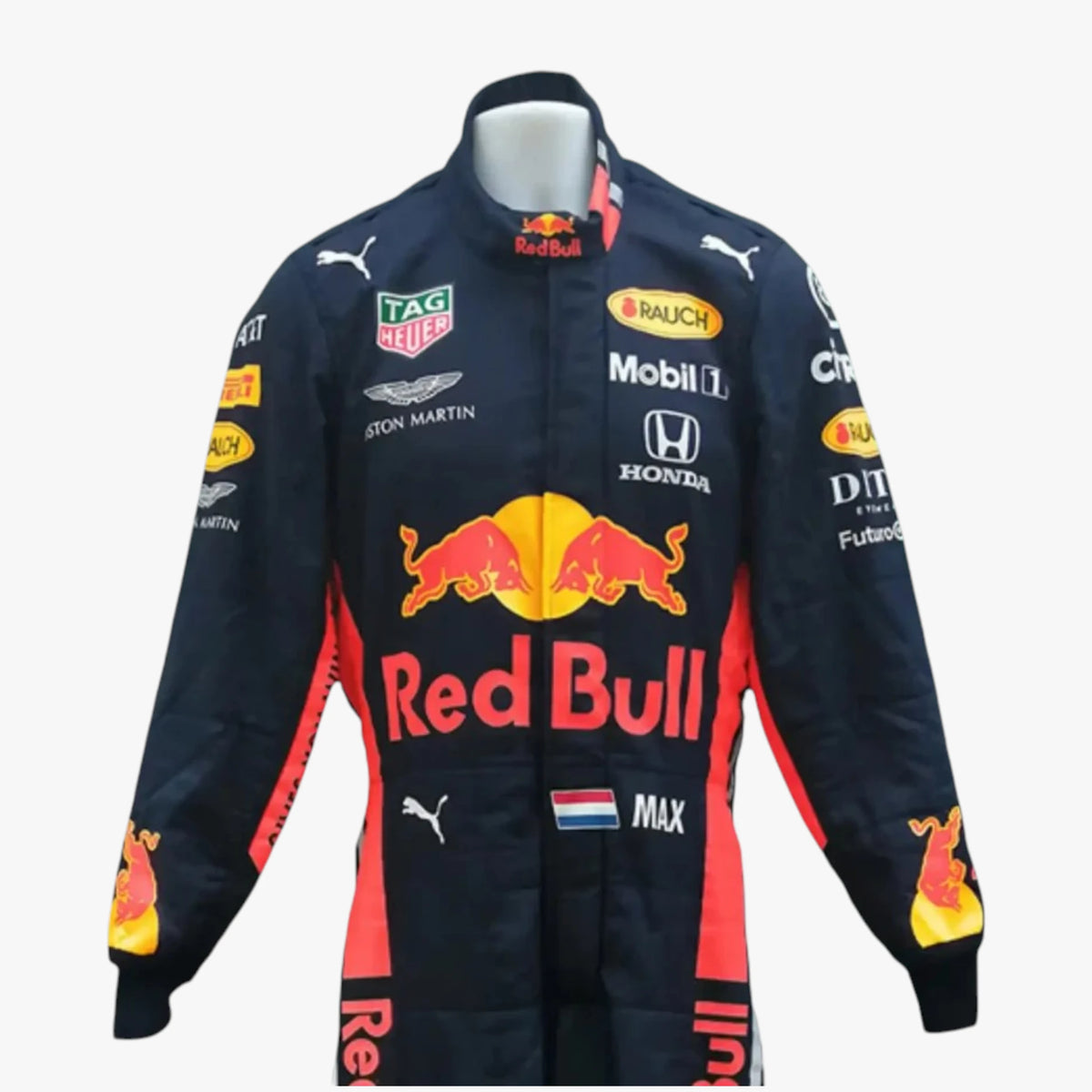 A Red Bull Racing team racing jacket displayed on a white mannequin torso against a light gray background. The jacket is primarily black with red and yellow accents, featuring sponsor logos such as TAG Heuer, Aston Martin, Honda, and Puma.