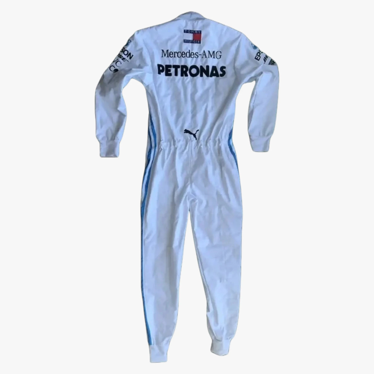 A light blue and white Mercedes-AMG Petronas racing one-piece suit with long sleeves, shown from the back against a plain white background. Visible brands include Mercedes-AMG, Petronas, Puma, and Tommy Hilfiger.