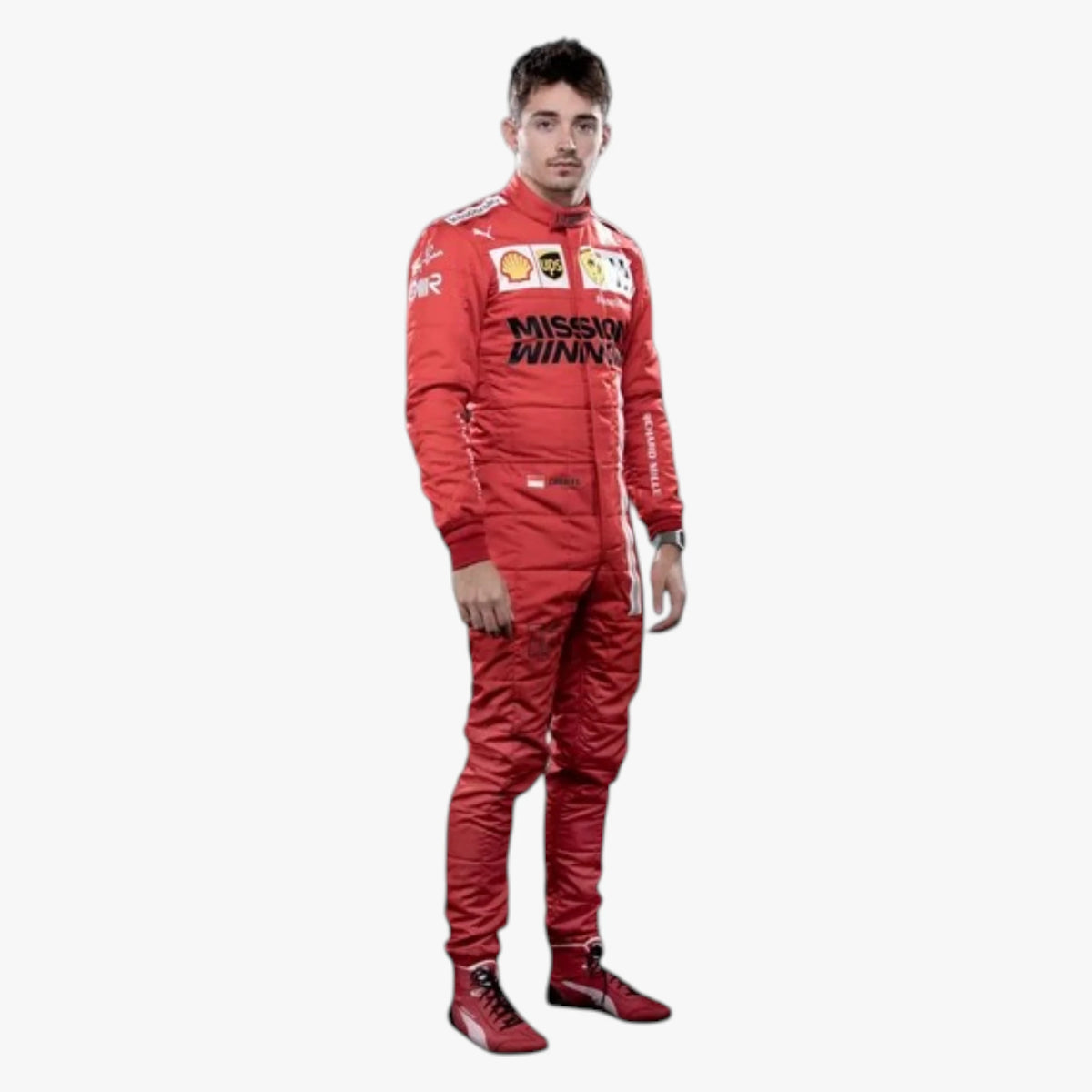 A man wearing a red racing suit with sponsor logos including Mission Winners and Shell, standing against a plain light gray background.