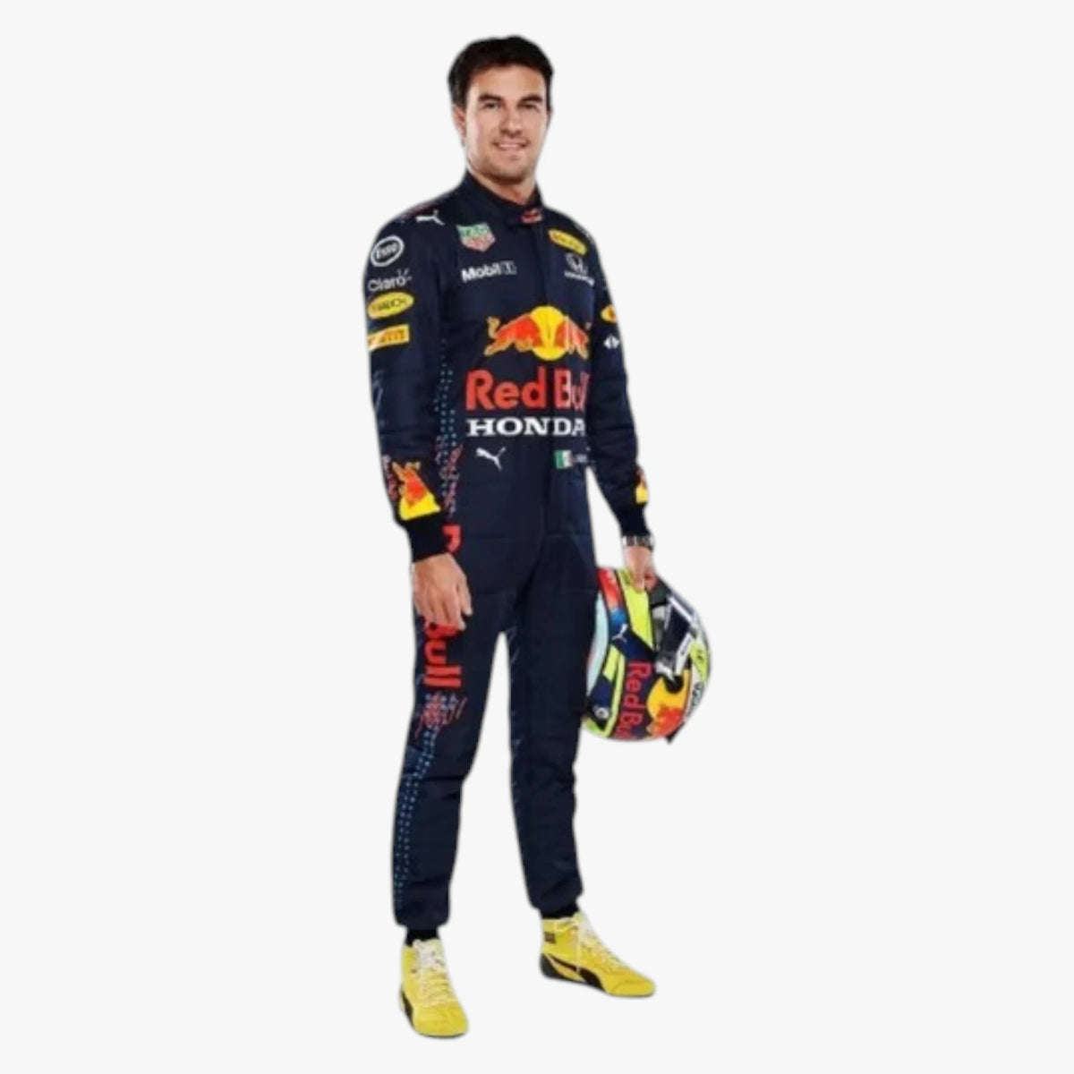 A man wearing a dark navy Red Bull Racing team suit with sponsor logos, holding a colorful racing helmet, standing against a plain light gray background.