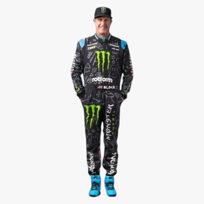 A man modeling a full racing suit and cap with Monster Energy branding, standing against a plain light gray background.