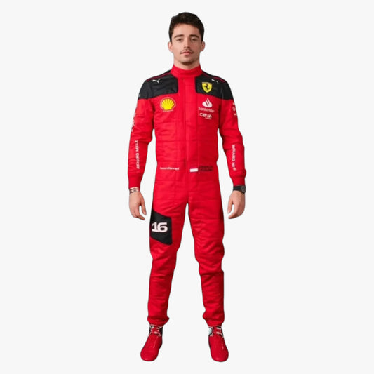 A man modeling a red Scuderia Ferrari full-body racing suit with black shoulder panels and various sponsor logos, paired with matching red racing shoes, against a plain light gray background.