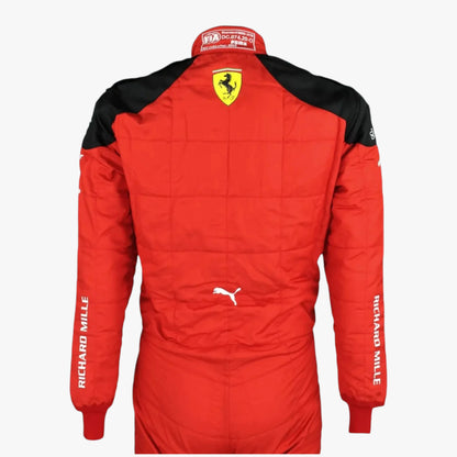 A red and black long-sleeve racing suit shown from the back, featuring the Ferrari shield logo on the upper back, a Puma logo, and 'RICHARD MILLE' printed down both sleeves, set against a plain light gray background.