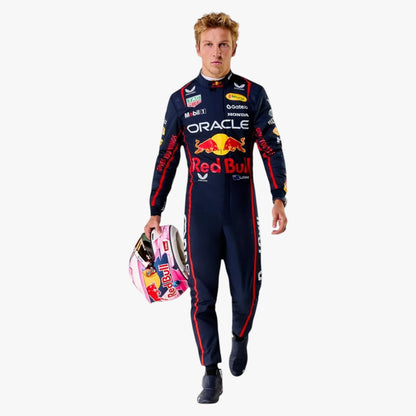 A man wearing a dark navy Red Bull Racing team racing suit with red and white sponsor logos, holding a pink and white racing helmet, set against a plain white background.