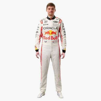 A man wearing a full Oracle Red Bull Racing driver's racing suit, standing against a solid light gray background. The suit is primarily off-white with red and black sponsor logos and stripes.