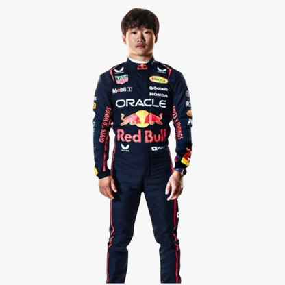 A man wearing a dark navy Red Bull Racing long-sleeve racing suit with multiple sponsor logos, including Oracle, Honda, and TAG Heuer, standing against a plain light gray background.