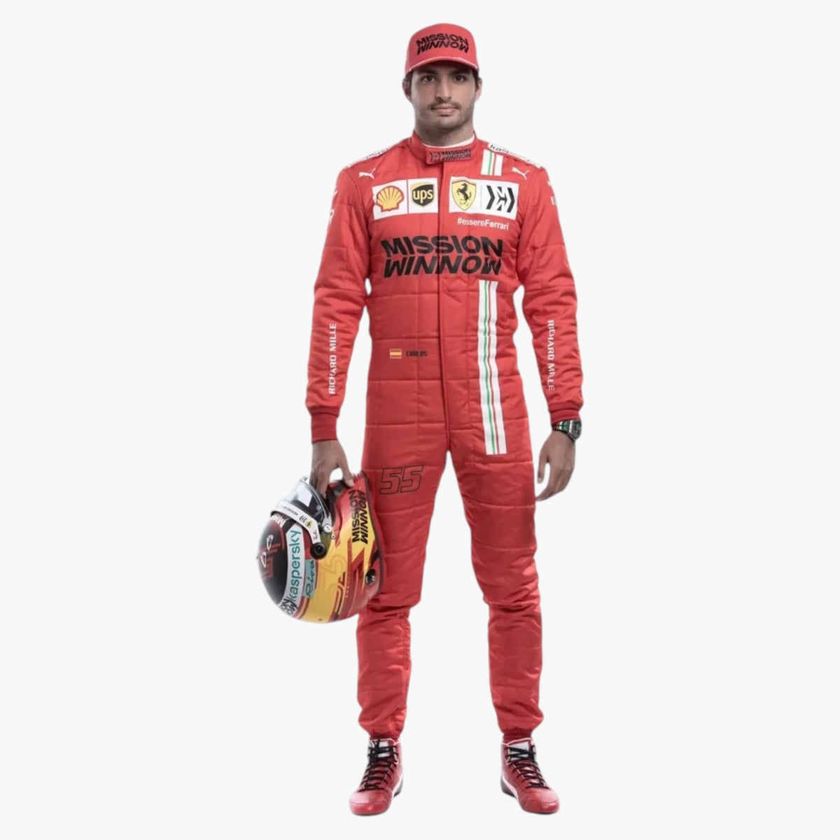 A full-body studio photo of a man wearing a red Ferrari racing suit and matching cap, holding a racing helmet. The suit has visible Ferrari, Puma, Shell, and Mission Winnow branding, and the model is standing against a plain light gray background.