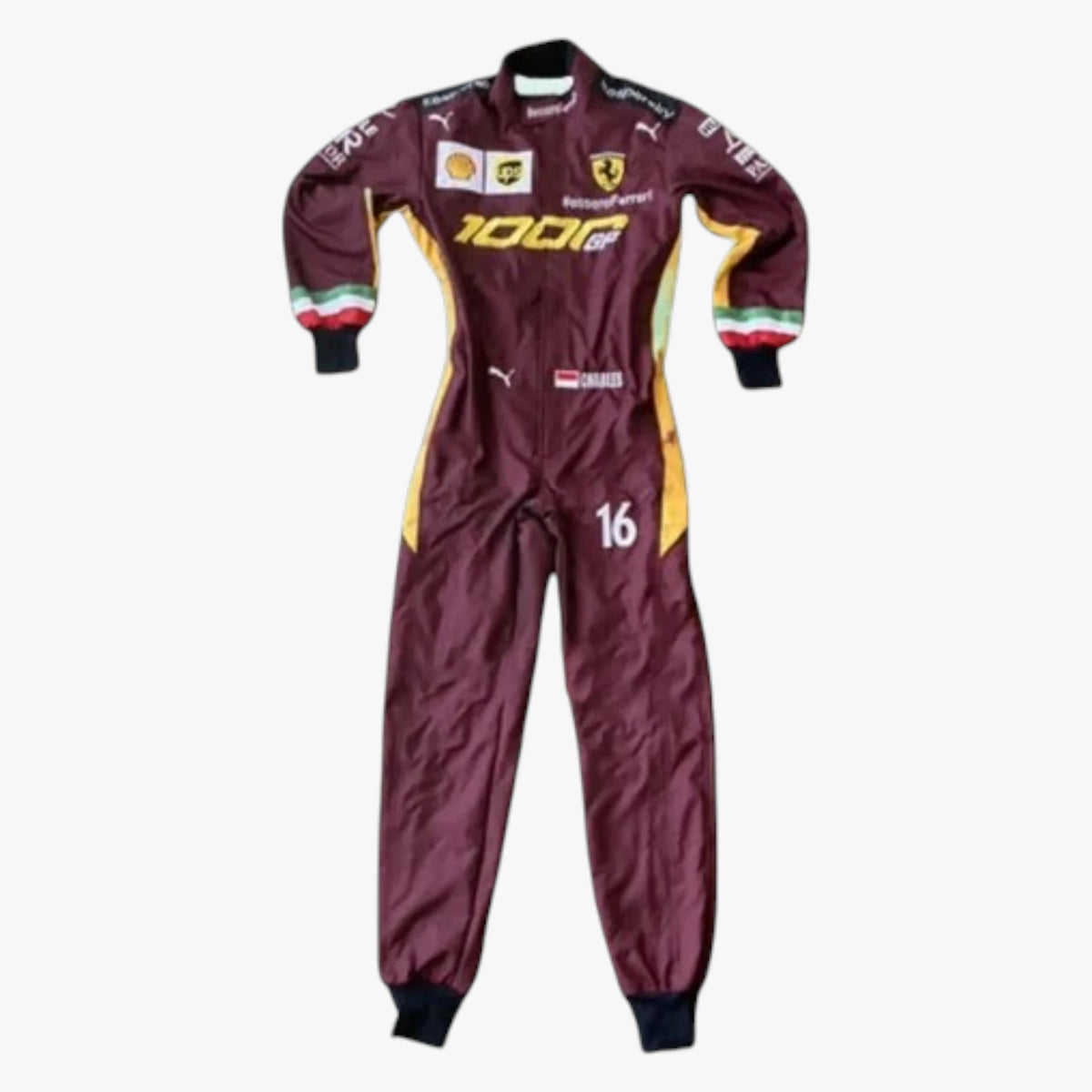A maroon Scuderia Ferrari Puma racing suit with yellow and green side panels, featuring sponsor logos including 100% and Castore, and the number 16 on the leg, shown against a plain white background.
