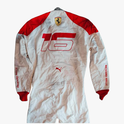 A white and red long-sleeve racing suit with '16' printed on the back, featuring the Ferrari shield logo on the neck, a Puma logo on the lower back, and 'RICHARD MILLE' printed down both sleeves.