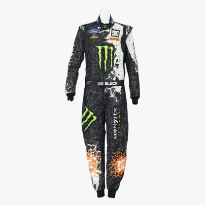 A full-length racing suit displayed on a mannequin against a light gray background. The suit is primarily black with a white splatter pattern, featuring prominent green Monster Energy logos, a Ford logo, and an orange crackle graphic near the lower leg.