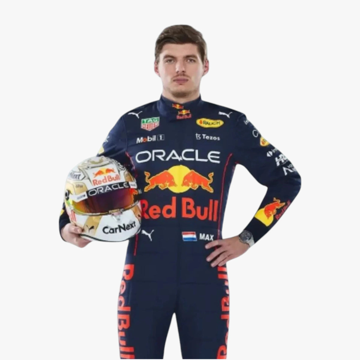 A man in a Red Bull racing suit holds a Red Bull helmet against a plain light gray background. The suit features prominent Oracle, Red Bull, Puma, and other sponsor logos.