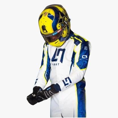 A driver in a white, blue, and yellow racing suit and matching helmet with the number 29, shown against a plain light gray background.