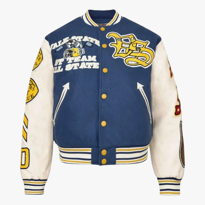 A varsity-style jacket with a navy blue body and off-white sleeves, featuring yellow and navy striped ribbed trim, gold buttons, and multiple collegiate graphics and patches.